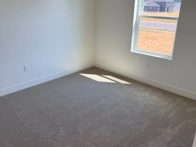 Neutral tone-on-tone carpeting complements crisp white walls