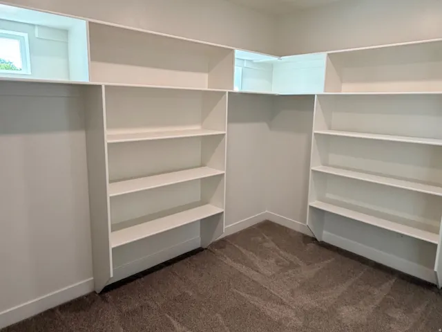 Built-in white shelving system featuring multiple tiers