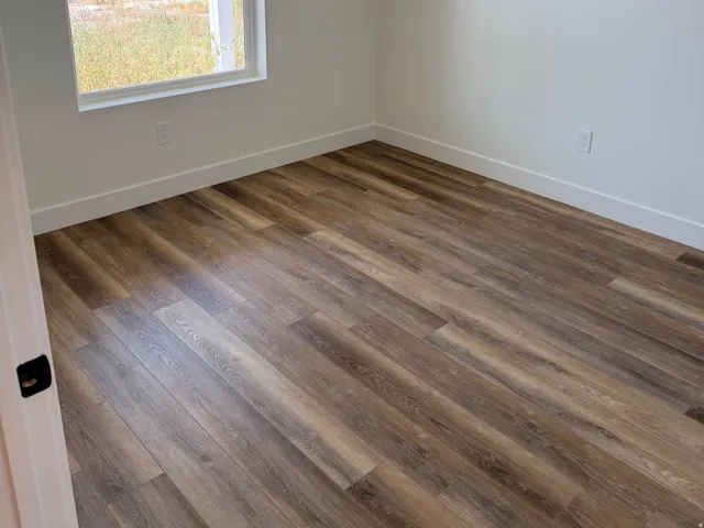 Room featuring wood-finish flooring, white baseboards, and neutral wall paint