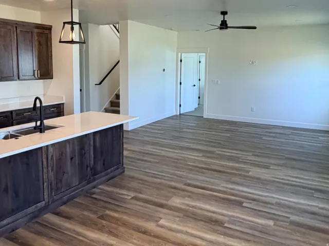 Open-concept living space featuring wood-finish flooring, recessed lighting, and a modern ceiling fan