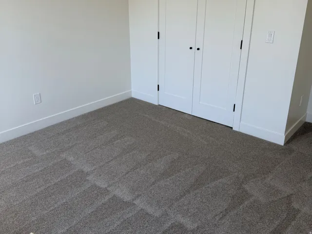 Neutral-toned walls complement the gray carpeting