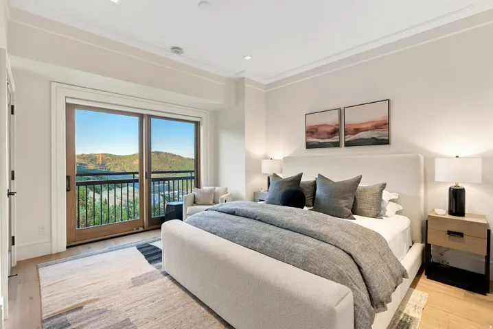 Wood-finish flooring throughout, featuring a full-light sliding door leading to a balcony with black metal railings