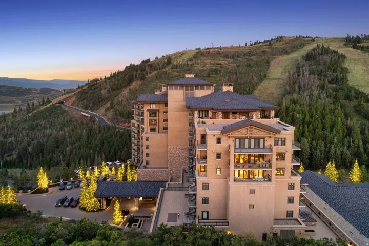 Striking contemporary architecture with warm terracotta-toned exterior, multi-level design, and expansive glazing