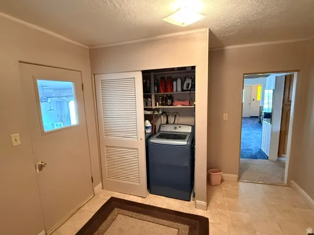 Utility closet featuring bi-fold louvered doors