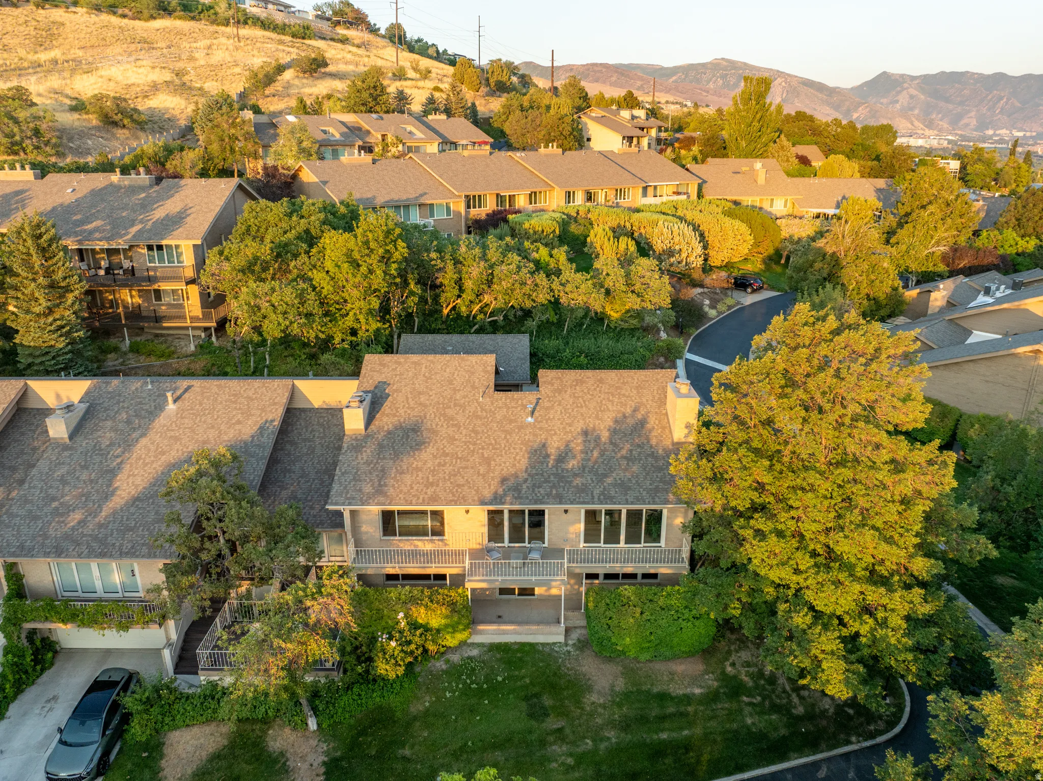 Elegant two-story residence showcasing a composite shingle roof, multi-pane windows, and a three-car garage with overhead doors