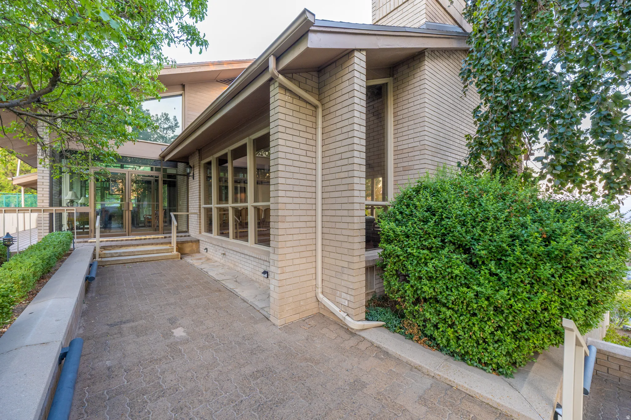 Contemporary home featuring clean-lined architecture with horizontal siding, substantial glass panels, and a covered entry portico