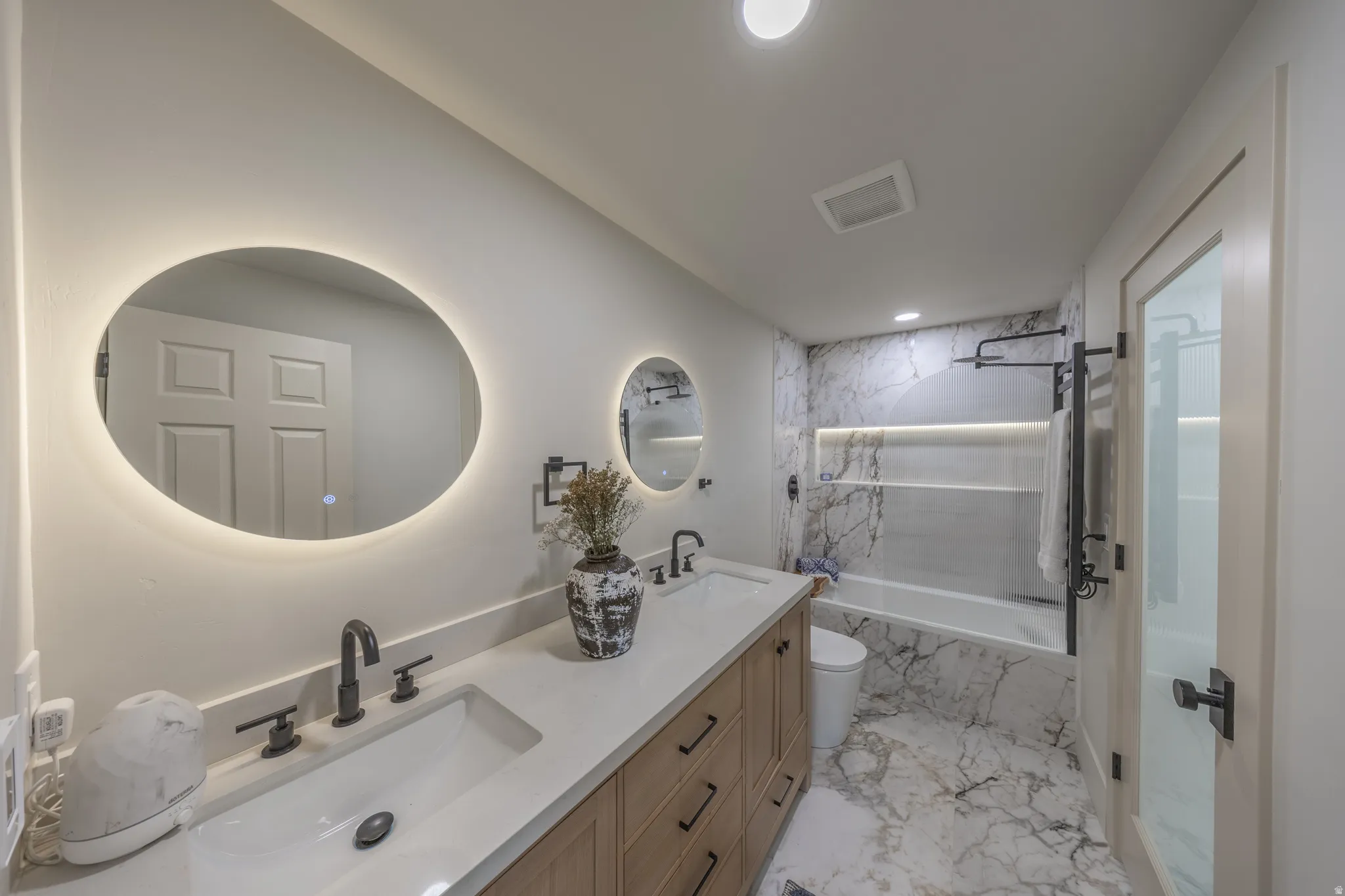 Dual vanity with integrated sinks and wood-finish cabinetry