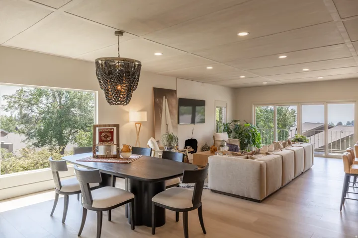 Recessed lighting, wood-finish flooring, full-height windows, coffered ceiling, and glass sliding doors