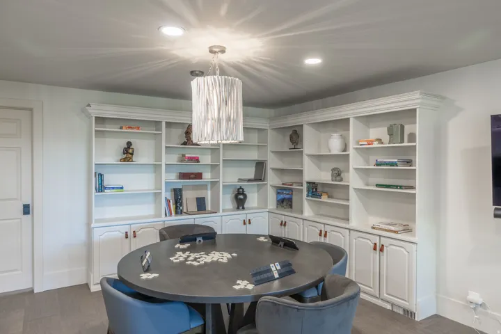 Built-in white cabinetry with open shelving and lower storage