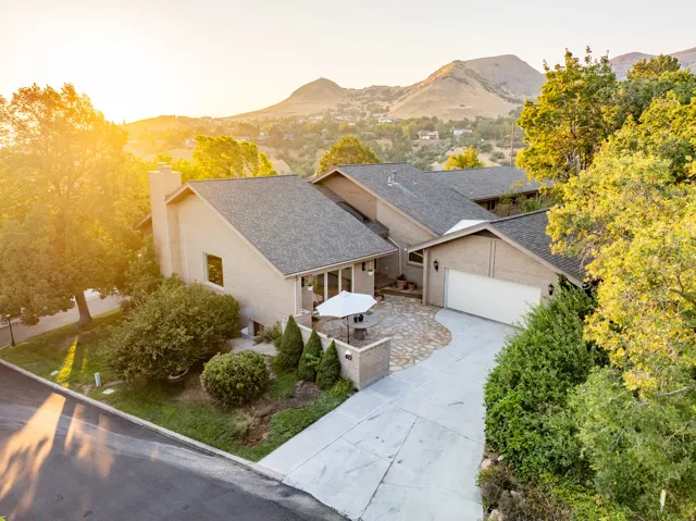 Modern single-story residence featuring a clean stucco exterior with a multi-pitched asphalt shingle roof