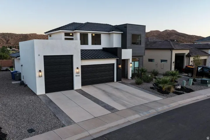 Modern two-story residence featuring a striking contemporary design with clean geometric lines and a mixed material palette