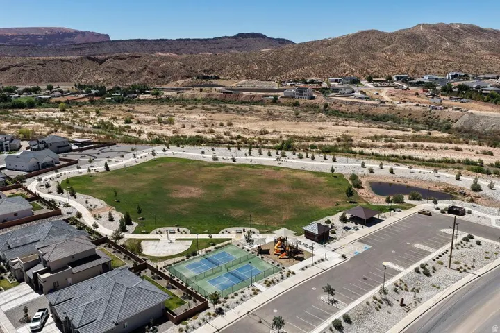 Expansive recreational facility featuring a pristine oval turf field with professional-grade playing surface, illuminated by stadium lighting