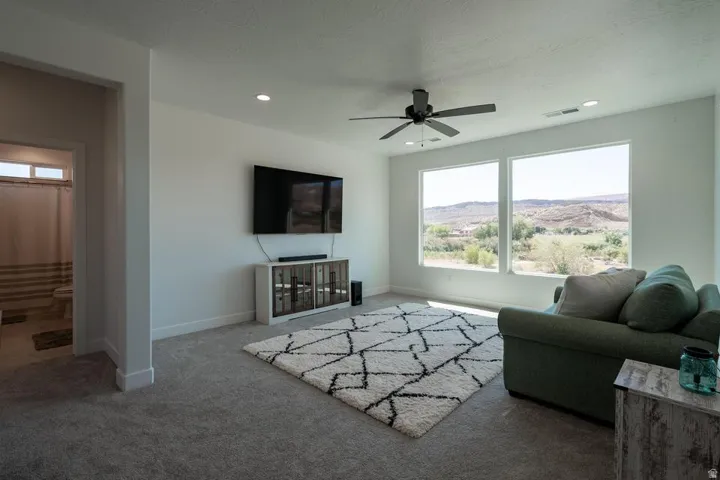 Living space featuring carpeted flooring and recessed lighting