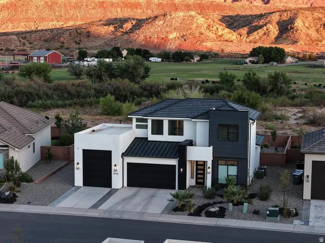 Modern two-story residence featuring a striking black and white exterior with clean geometric lines