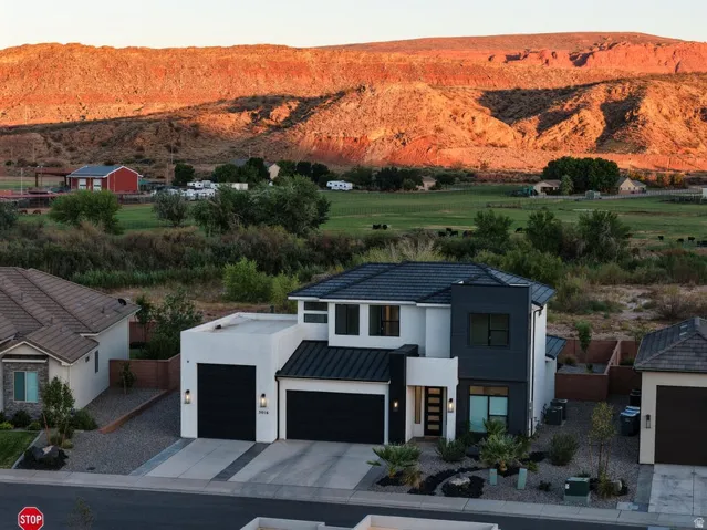 Modern two-story residence featuring a clean-lined architectural design with contrasting white and dark metal accents