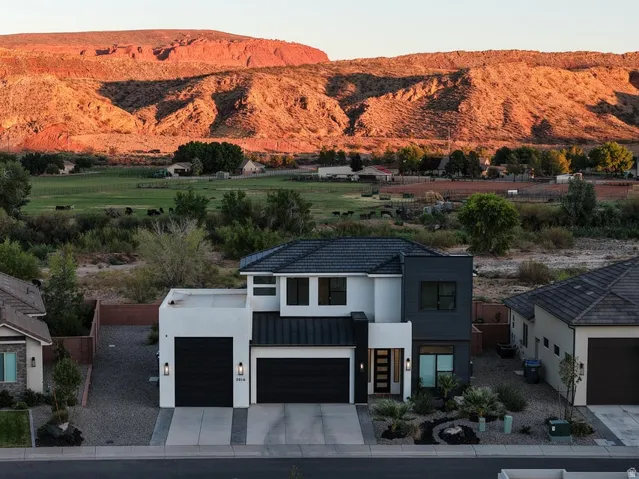 Contemporary architecture featuring a two-story design with a flat roofline and a dark tile roof