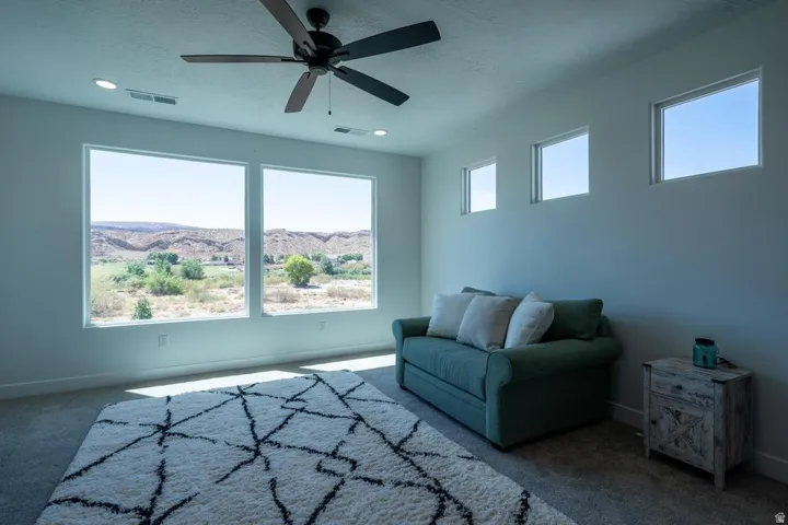 Expansive windows showcasing distant desert mountains and green vegetation