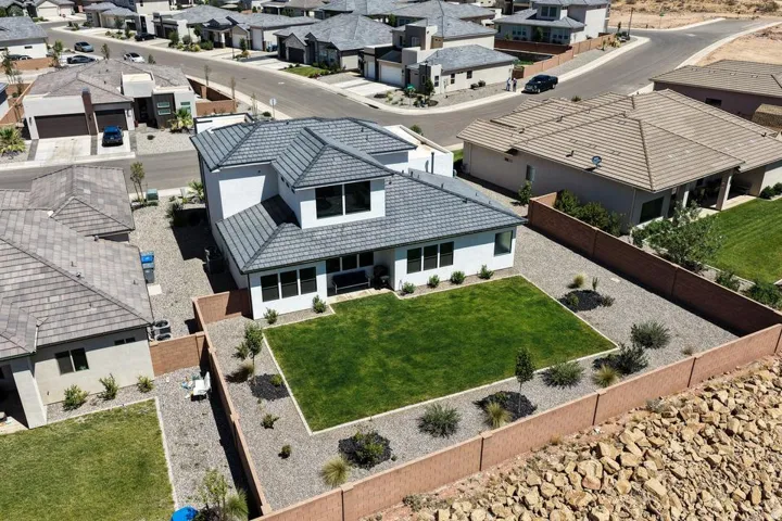 Modern two-story residence featuring a gray tile roof and white exterior siding
