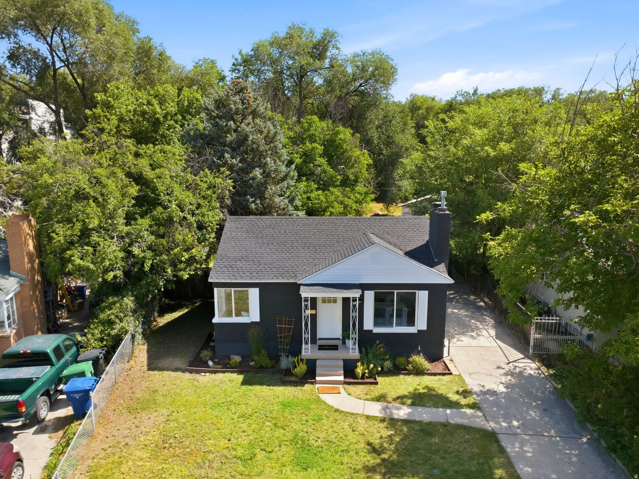 Charming single-story home featuring a dark exterior with fresh architectural appeal