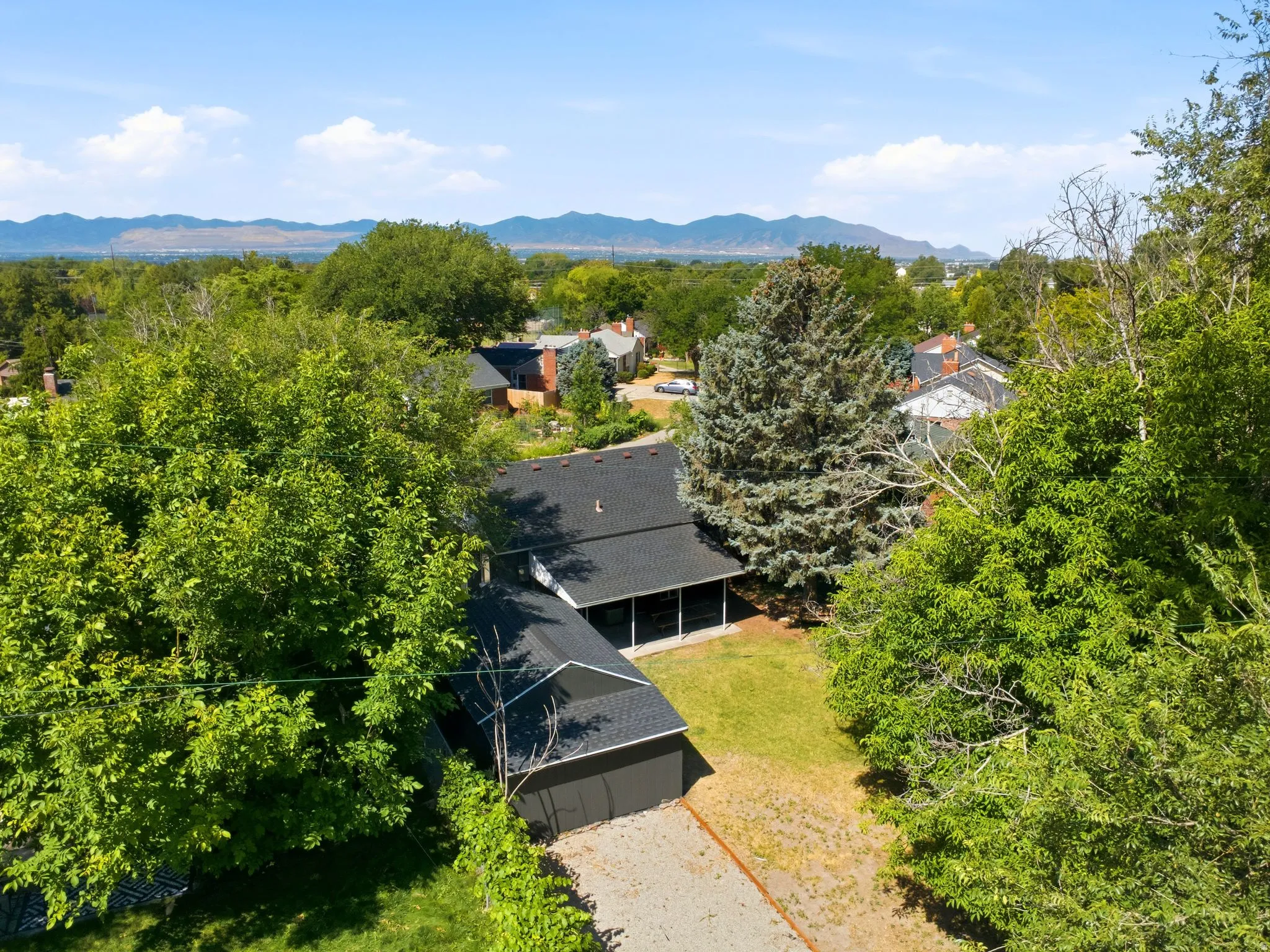 Aerial perspective showcasing a residential property and surrounding landscape