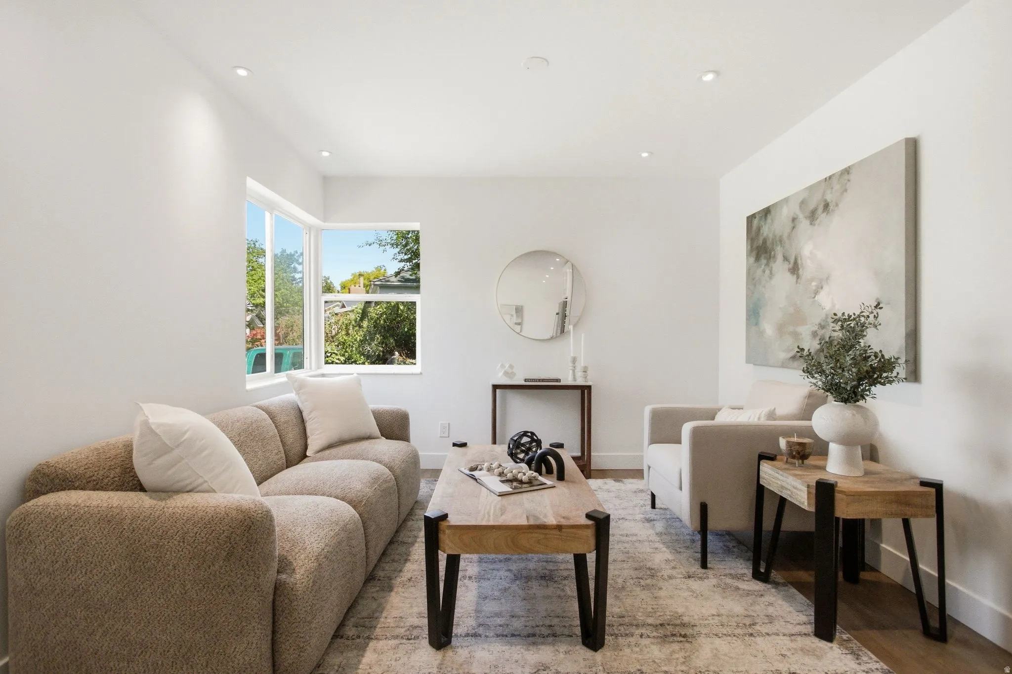 Open-concept living space featuring recessed lighting, light wood-finish flooring, and white walls