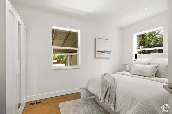 Room featuring light wood-finish flooring, white walls, and recessed lighting