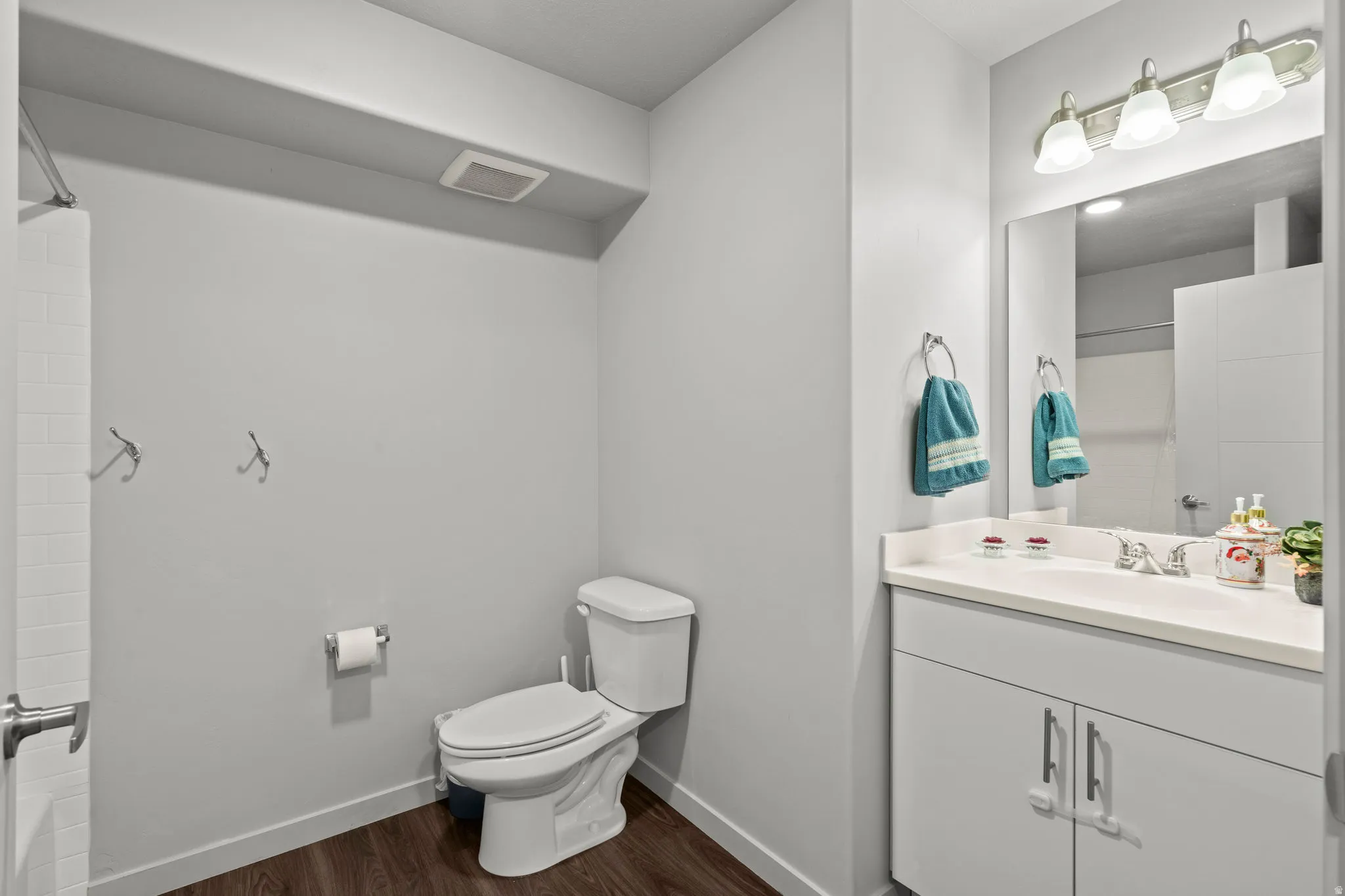 Modern bathroom featuring a dual-sink vanity with white cabinetry, brushed nickel hardware, and ample counter space
