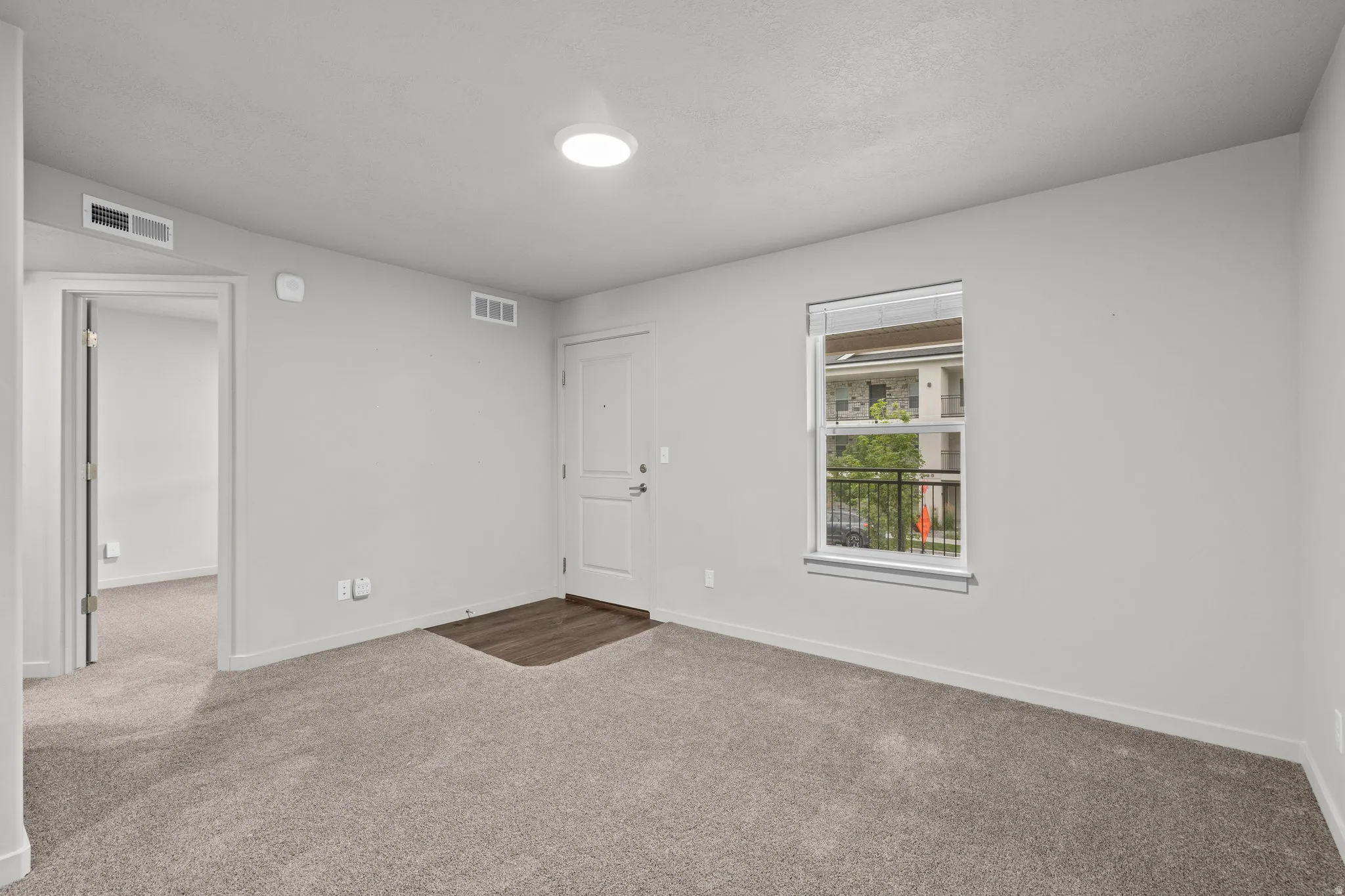 Spacious bedroom featuring neutral wall finishes, recessed ceiling lighting, and plush carpet flooring