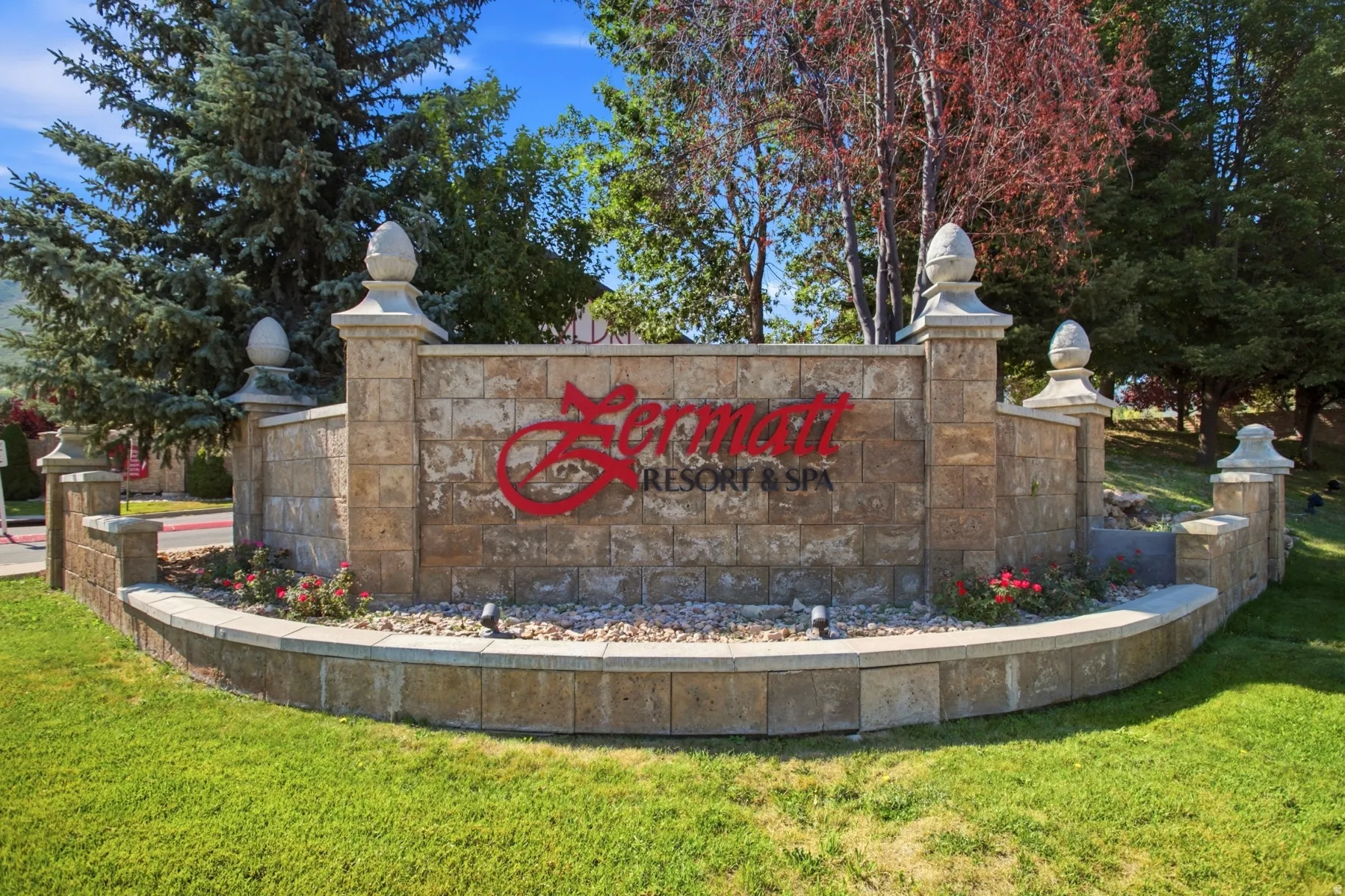 Stone entrance monument with decorative finials