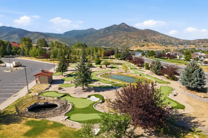 Expansive recreational grounds featuring a professionally designed mini golf course with multiple fairways, manicured putting greens, and sand bunkers