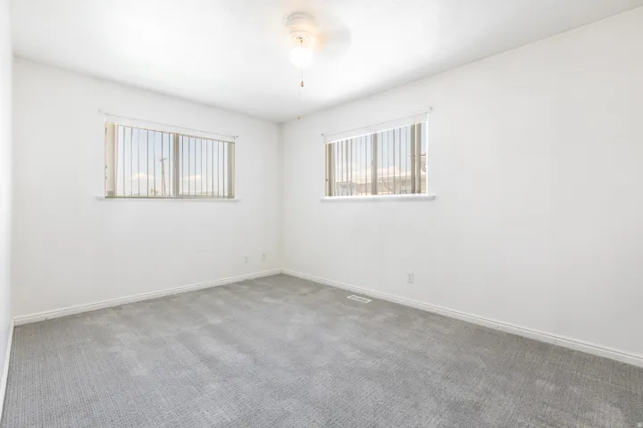 Spacious Owners Suite featuring walk-in closet and built-in Ironing Board, and walk-in shower..