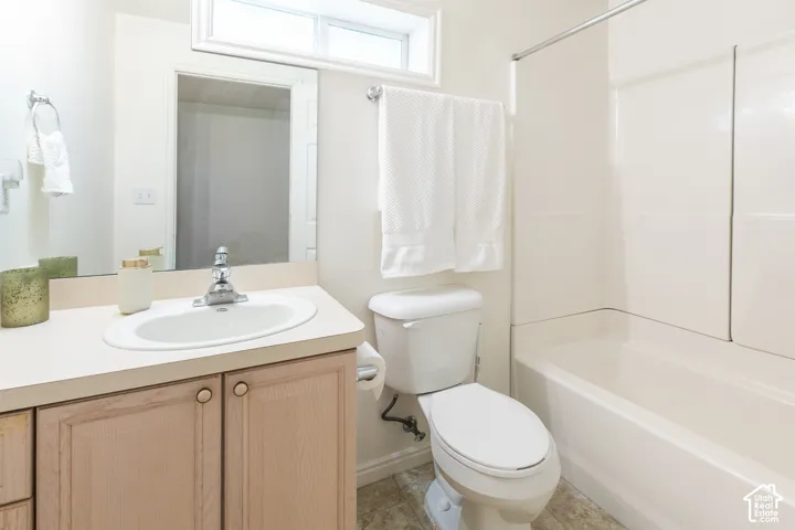 Basement Full Bath with full tub and a large mirror
