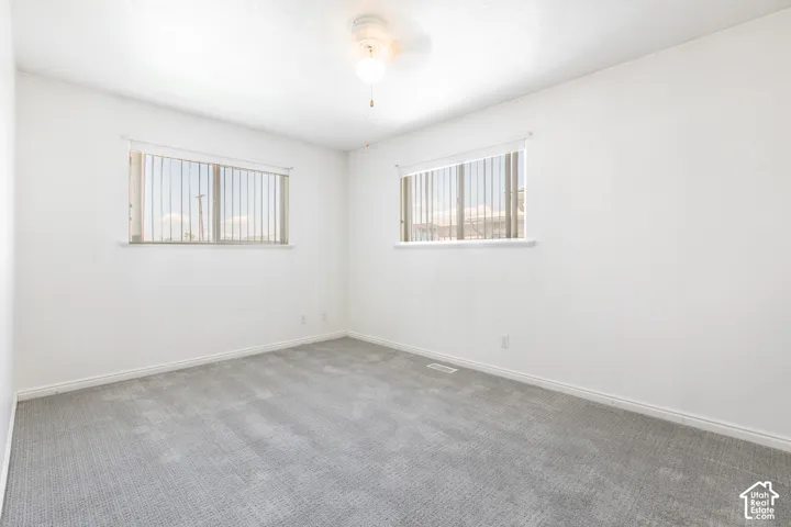 Spacious Owners Suite featuring walk-in closet and built-in Ironing Board, and walk-in shower..