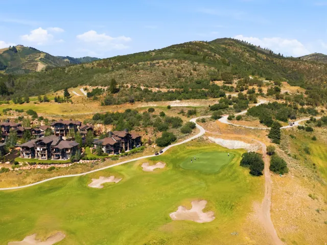 Championship-caliber golf course featuring meticulously manicured fairways, strategically positioned sand bunkers, and mature landscape plantings throughout the property