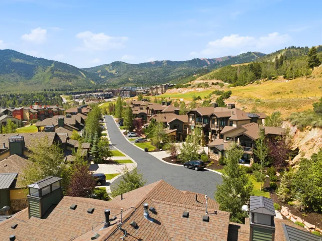 Residential community featuring diverse architectural styles, paved roadways, and landscaped grounds