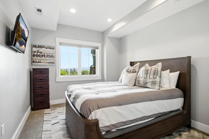 Bedroom featuring a large window, recessed lighting, and light gray wall paint