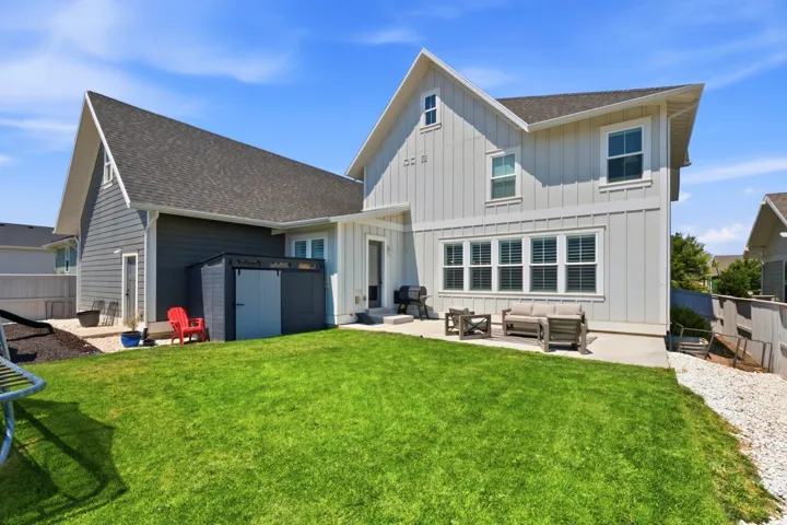 Modern farmhouse residence showcasing a clean-lined exterior with board-and-batten siding, multiple gabled rooflines with dimensional shingle detailing, and expansive multi-pane windows