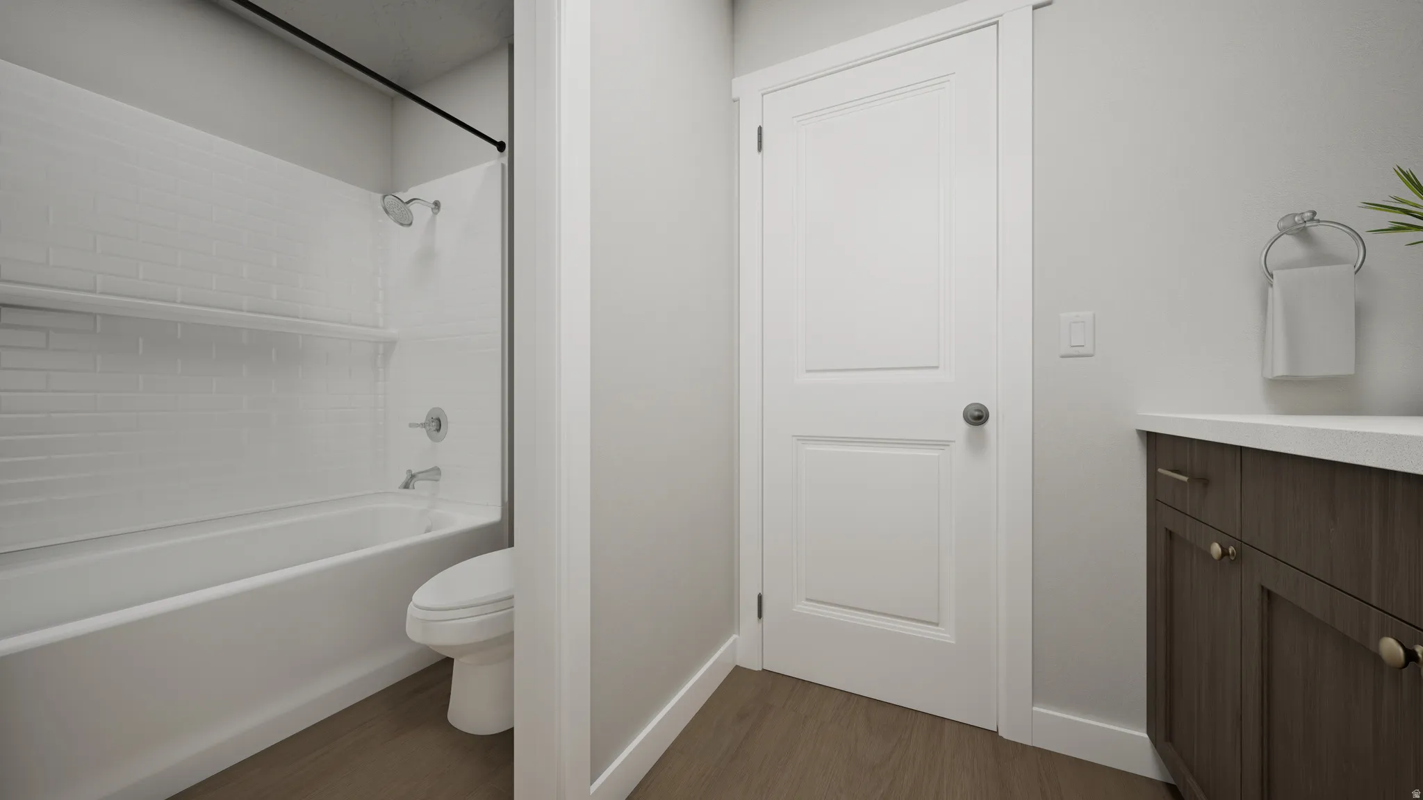 Bathroom featuring a white subway tile shower surround, chrome fixtures, dark wood-finish vanity with paneling, and a white countertop