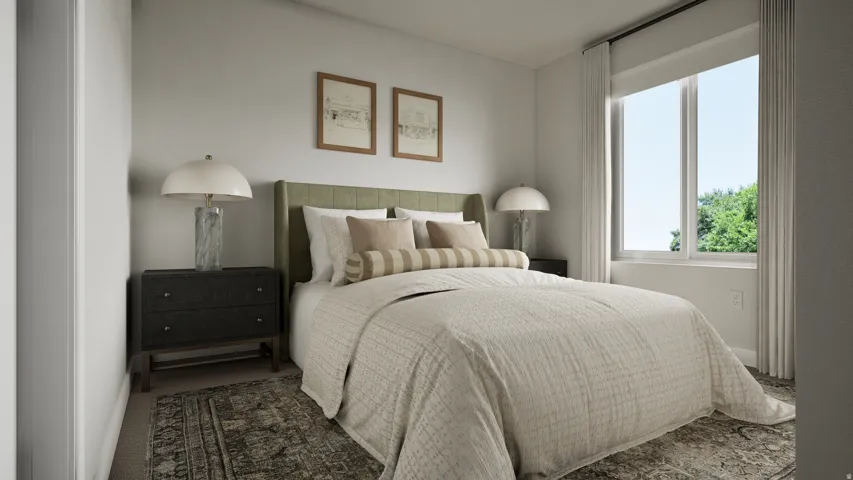 Bedroom featuring light-toned walls, a large window, and carpeted flooring