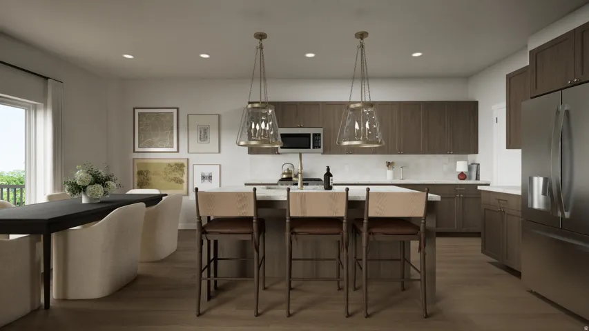 Modern kitchen featuring wood-finish flooring, full-height cabinetry, stainless steel appliances, and a central island with pendulum lighting