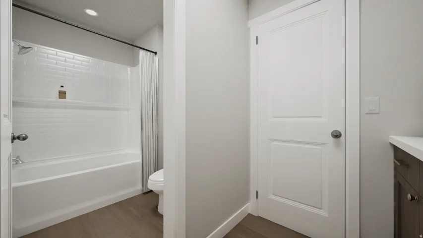 Bathroom featuring a white subway tile shower surround with integrated niche, chrome shower fixtures, and a white bathtub