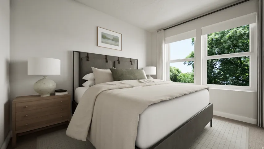 Light-filled bedroom featuring two large windows with roller shades, neutral color palette, and light wood-finish flooring
