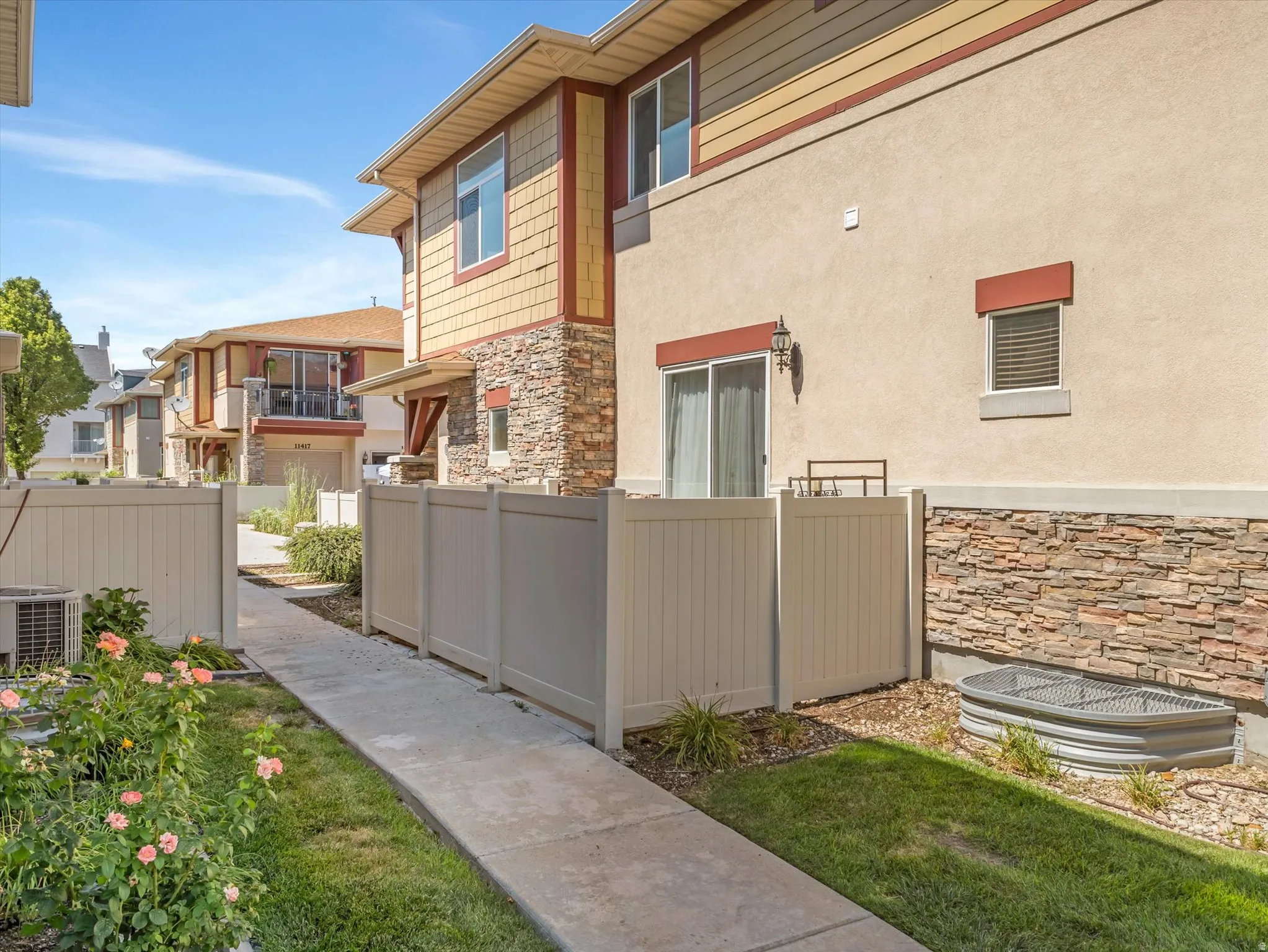 Exterior showcasing stucco siding with stone veneer accents