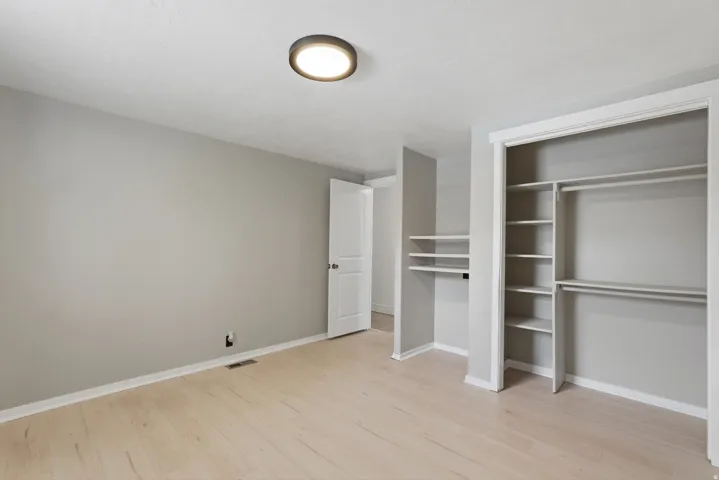 Light wood-finish flooring complements the neutral wall tones