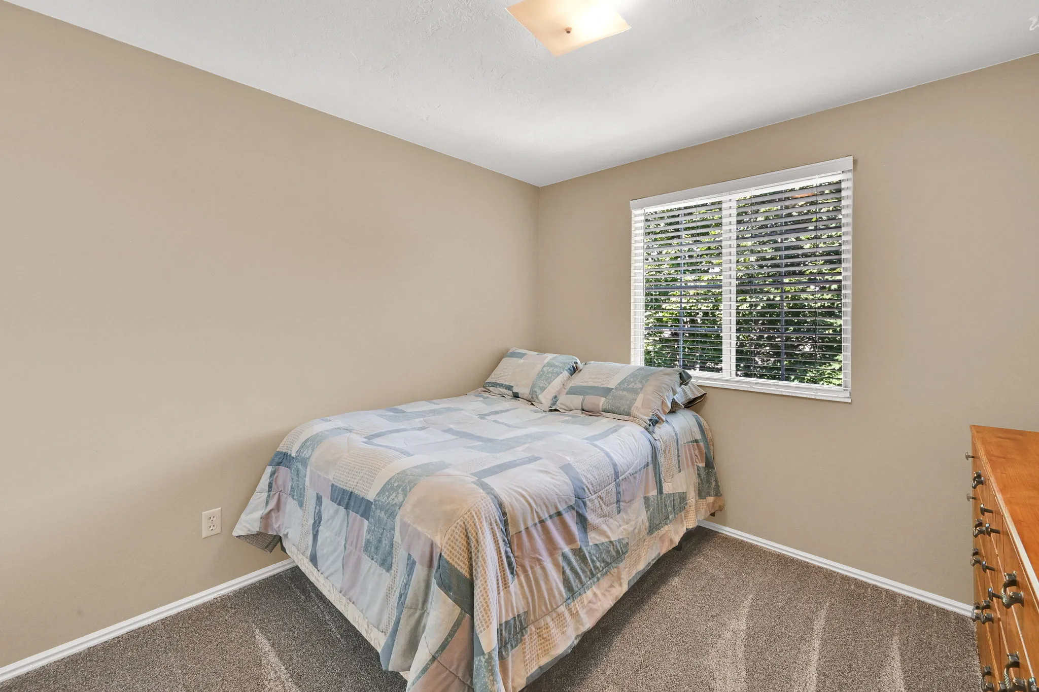 Room featuring neutral wall tones and a single window with horizontal blinds