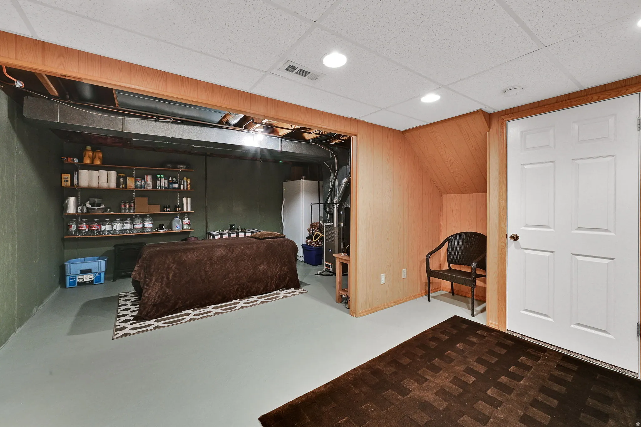 Lower level area featuring a drop ceiling with recessed lighting