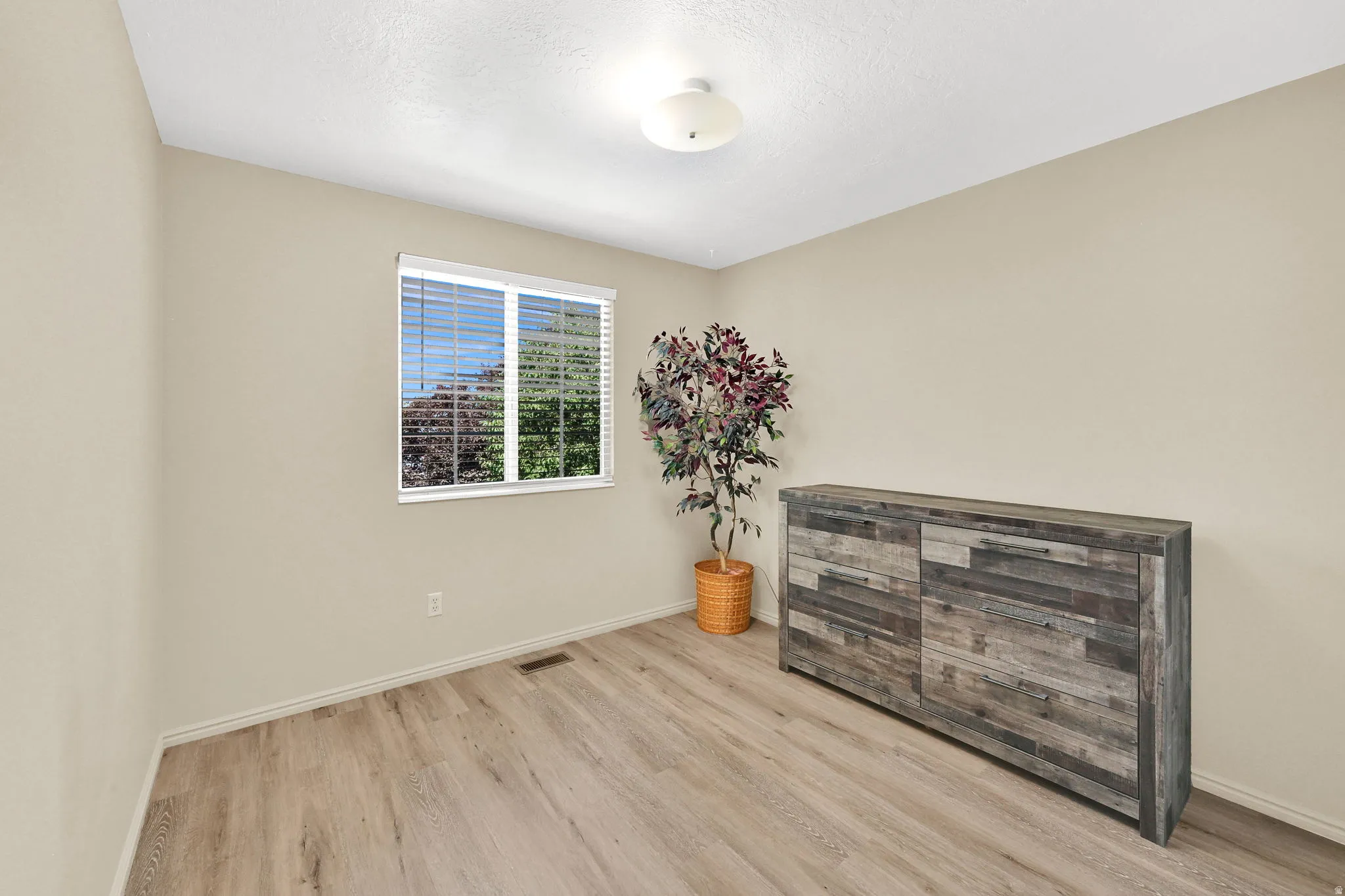 Light-toned walls complement wood-finish flooring
