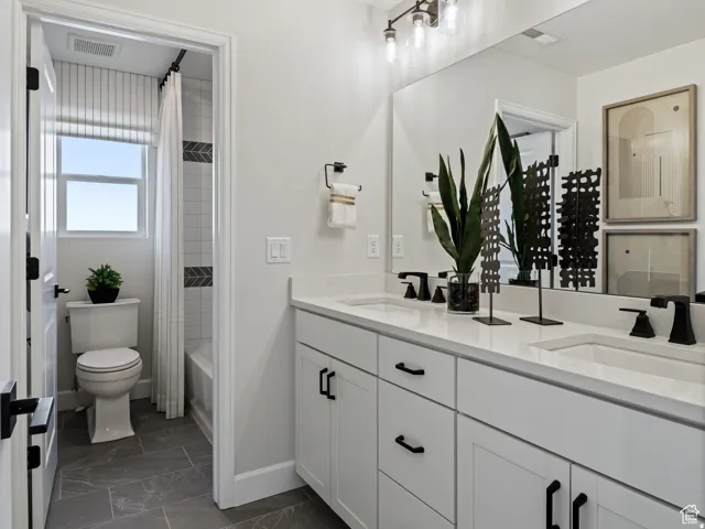 Dual vanity featuring white shaker-style cabinetry, white countertops, and matte black fixtures