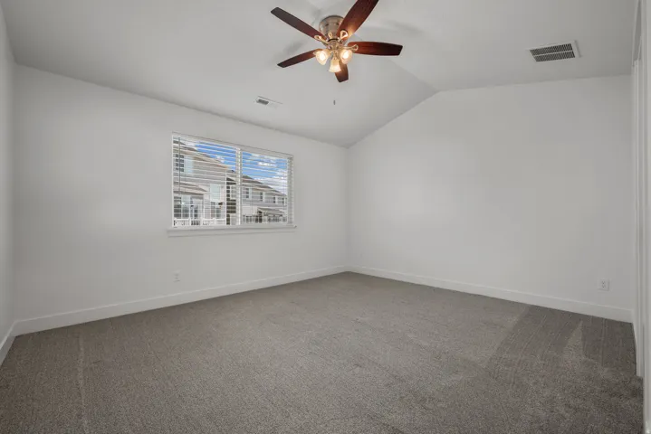 Spacious Master featuring neutral carpeting, recessed ceiling lighting, and a ceiling fan with integrated light fixture