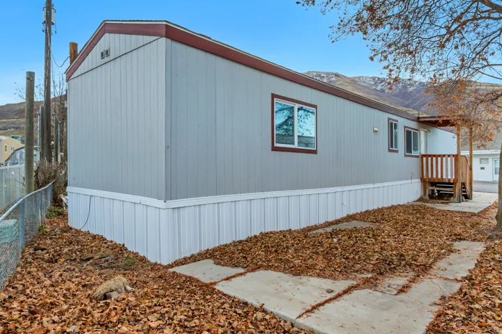 Light gray vertical siding with white foundation skirting